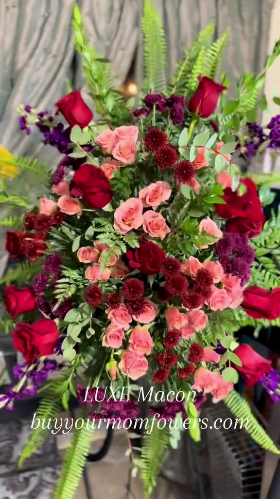 Floral standing spray in shades of red by LUXE Macon.